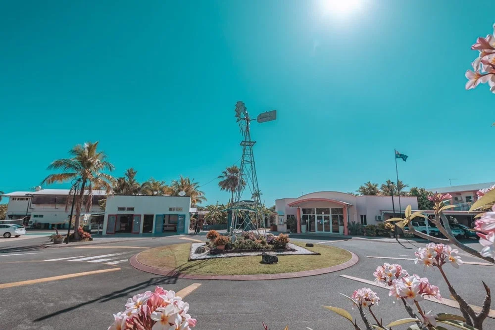 風車とヤシの木が並ぶ熱帯の風景