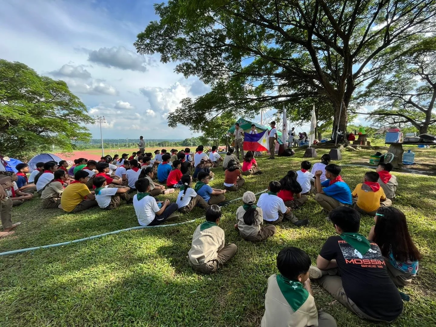 屋外で集会に参加する子供たち